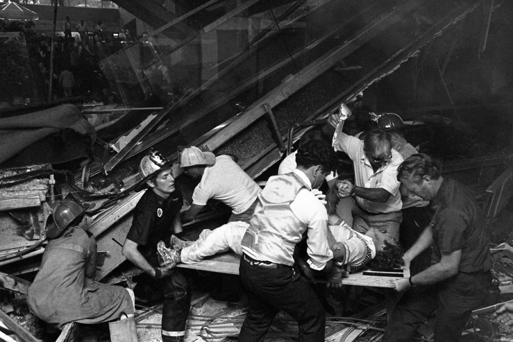 In 1981, firefighters work to free people trapped under the fallen walkway at the Hyatt Regency Hotel in Kansas City. (Bettman Archive via Getty)